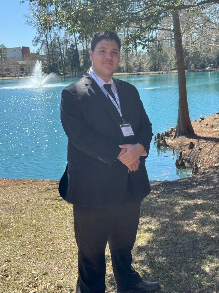 Pacheco se encuentra frente a una fuente en el campus de Statesboro.