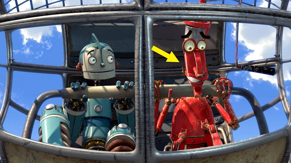 Dos robots animados, uno azul y otro rojo, en un dispositivo volador, luciendo sorprendidos o emocionados.